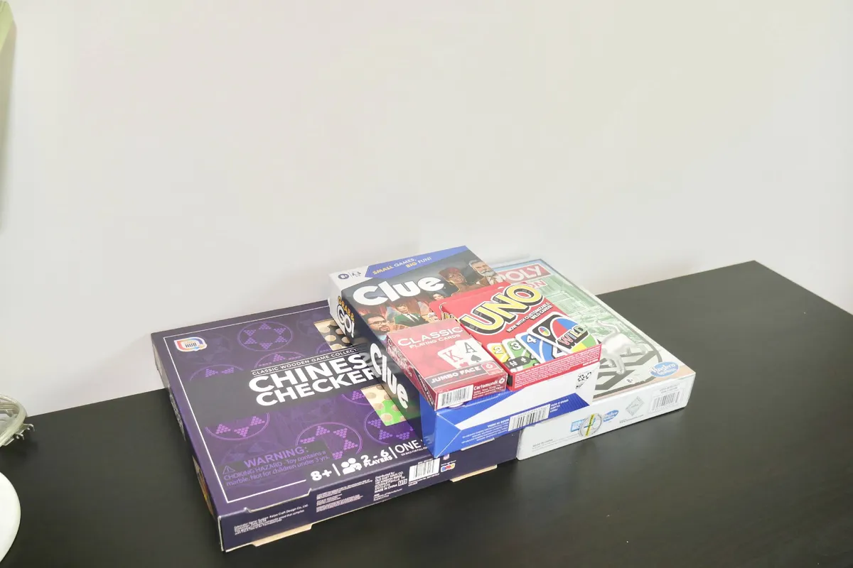 A playful scene with a variety of board games spread out on a table, ready for family or friends to enjoy an evening of fun and laughter.